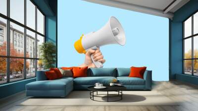 Female hand with megaphone on blue background Wall mural