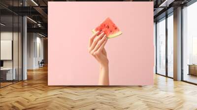 Female hand with piece of juicy watermelon on color background Wall mural