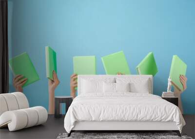 Female hands with books on color background Wall mural