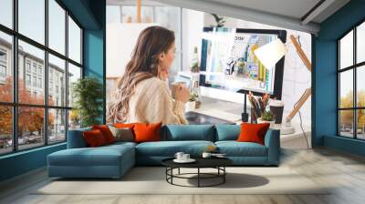 Female interior designer working in office Wall mural