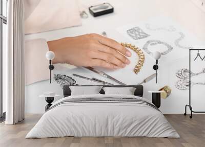 Female jewelry designer working with sketches of stylish accessories in office Wall mural