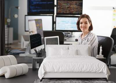 Female programmer working in office Wall mural