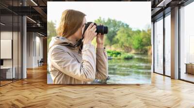 Female tourist taking photo of river Wall mural