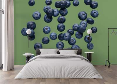 Flying fresh blueberries on green background Wall mural