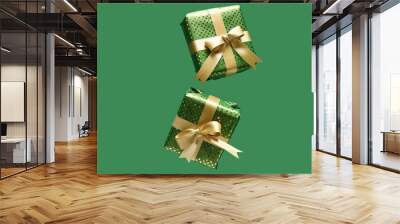 Flying gift boxes on green background Wall mural