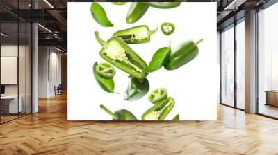 Flying green jalapeno peppers and fresh basil leaves on white background Wall mural