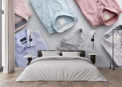 Folded male shirts on light background Wall mural