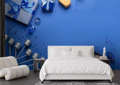 Frame made of plate with donuts, menorah and gifts for Hanukkah celebration on blue background Wall mural