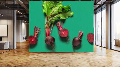 Fresh beets with leaves on green background Wall mural