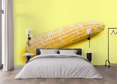 Fresh corn cob on yellow background Wall mural