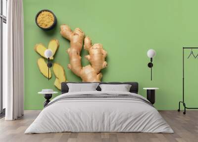 Fresh ginger root and bowl of dried powder on green background Wall mural