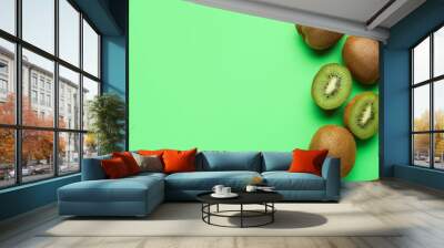 Fresh kiwi fruit with pieces on color background Wall mural