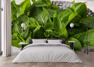 Fresh mint leaves on wicker bowl Wall mural