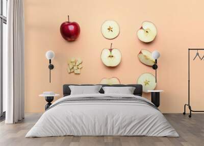 Fresh red apple with different pieces and seeds on color background Wall mural