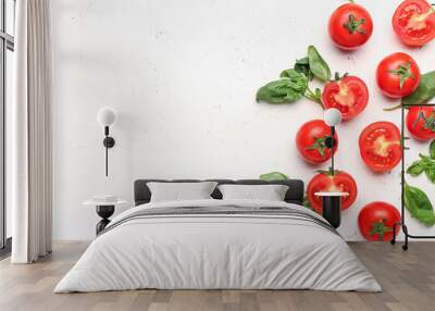 Fresh ripe tomatoes and basil leaves on light background Wall mural