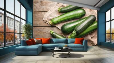 Fresh zucchini squashes on wooden background Wall mural