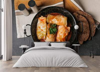 Frying pan with tasty stuffed cabbage rolls on dark background Wall mural