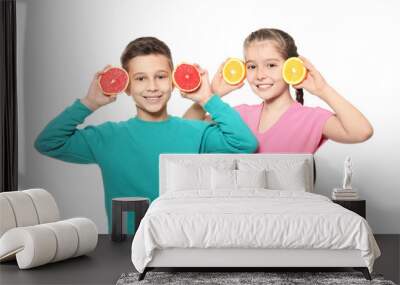 Funny little children with citrus fruits on white background Wall mural