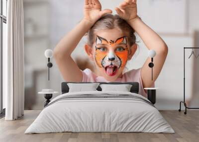 Funny little girl with face painting at home Wall mural