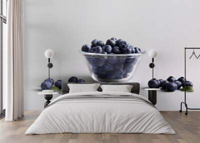 Glass bowl of fresh ripe blueberry on white background Wall mural