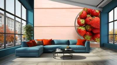 Glass bowl with fresh strawberry on color wooden background, closeup Wall mural