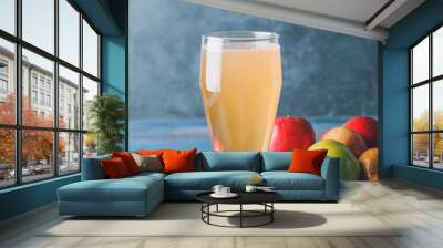 Glass of apple cider on wooden table Wall mural