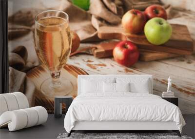 Glass of fresh apple cider on table Wall mural