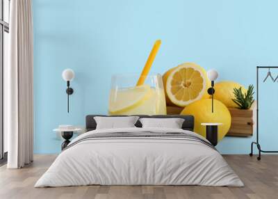 Glass of fresh lemonade with sugar and rosemary on blue background Wall mural