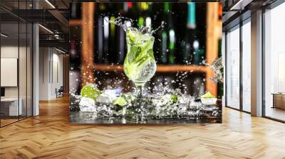 Glass of fresh mojito with splashes on table in bar Wall mural