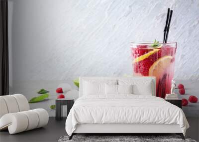 Glass of fresh raspberry mojito on table Wall mural