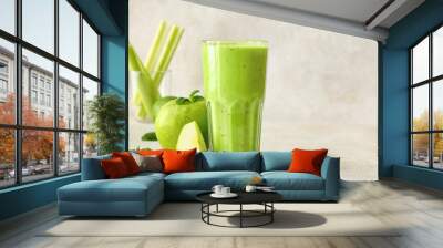 Glass of healthy green juice and fresh apple on light background Wall mural