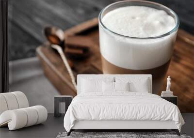 Glass of tasty aromatic latte on wooden board Wall mural