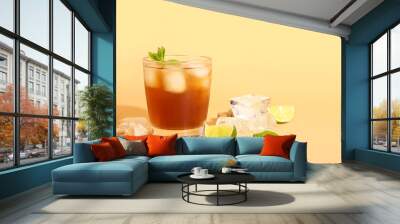 Glass of tasty Long Island iced tea on color background Wall mural