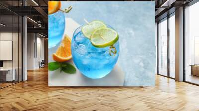 glasses of blue lagoon cocktail on color background, closeup Wall mural