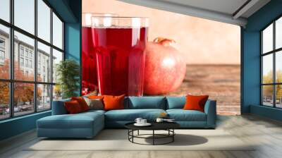 Glasses of fresh pomegranate juice on wooden table, closeup Wall mural