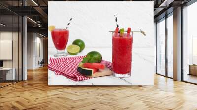 Glasses of fresh watermelon juice with lime and mint on white background Wall mural