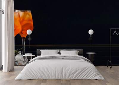 Glasses of tasty Aperol Spritz cocktail on dark background with space for text Wall mural