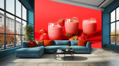 Glasses of tasty strawberry smoothie on color background Wall mural