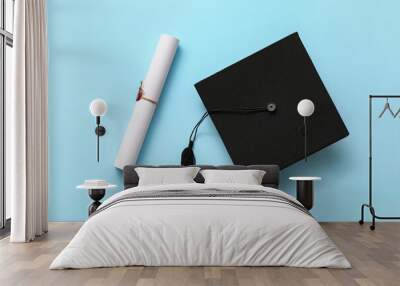 Graduation hat and diploma on color background Wall mural