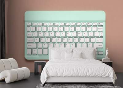 Green computer keyboard on brown background. Top view Wall mural