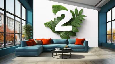 Green leaves with paper number two on white background. Top view Wall mural