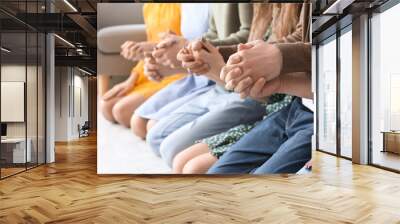 Group of people praying with Holy Bible on floor, closeup Wall mural