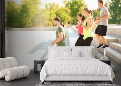 Group of sporty people training outdoors Wall mural