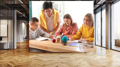 Group of teenage students with boy in wheelchair studying at school Wall mural