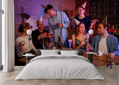 Group of young friends with champagne celebrating Birthday at night Wall mural