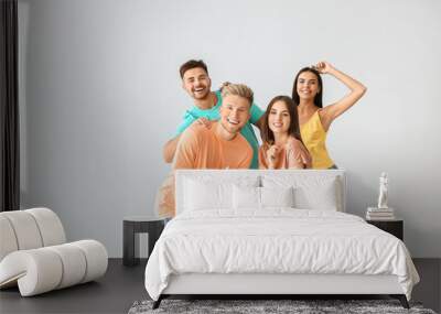 Group of young people in stylish casual clothes on light background Wall mural