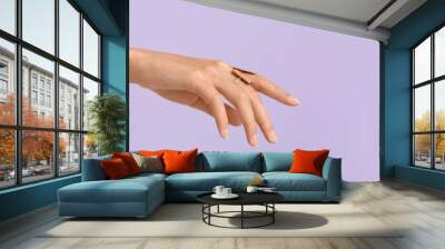 Hand of beautiful woman wearing stylish jewellery on lilac background with space for text Wall mural