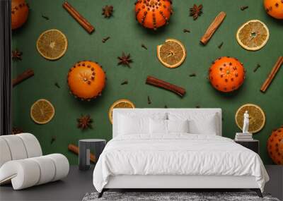 Handmade Christmas decoration made of tangerines with cloves on green background Wall mural