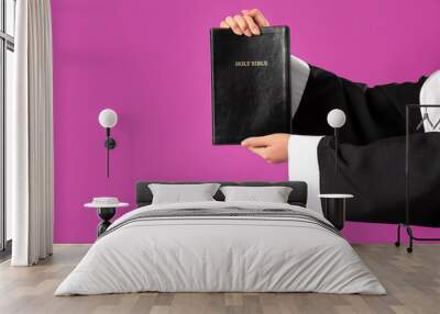 Hands of young Asian nun with Bible on purple background, closeup Wall mural