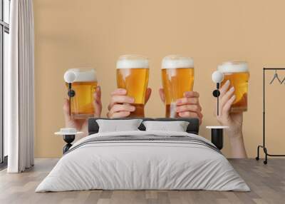 Hands with glasses of beer on color background Wall mural